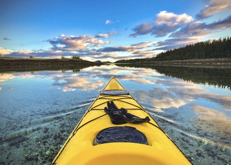view of the sunset in the lake in a yellow boat